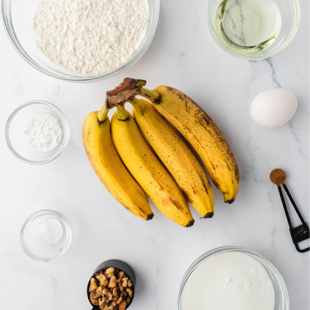 All the items needed to bake banana bread laying on a counter.