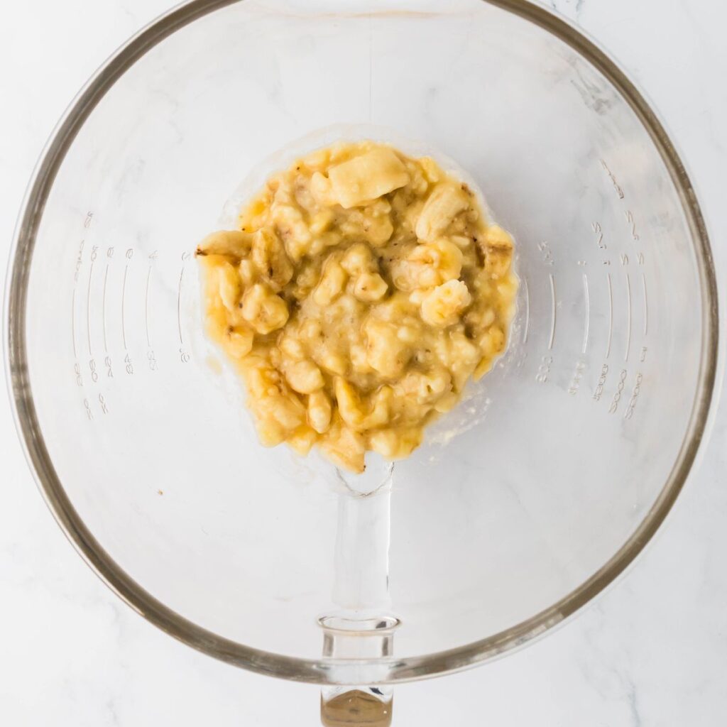 Mashing bananas in a bowl.