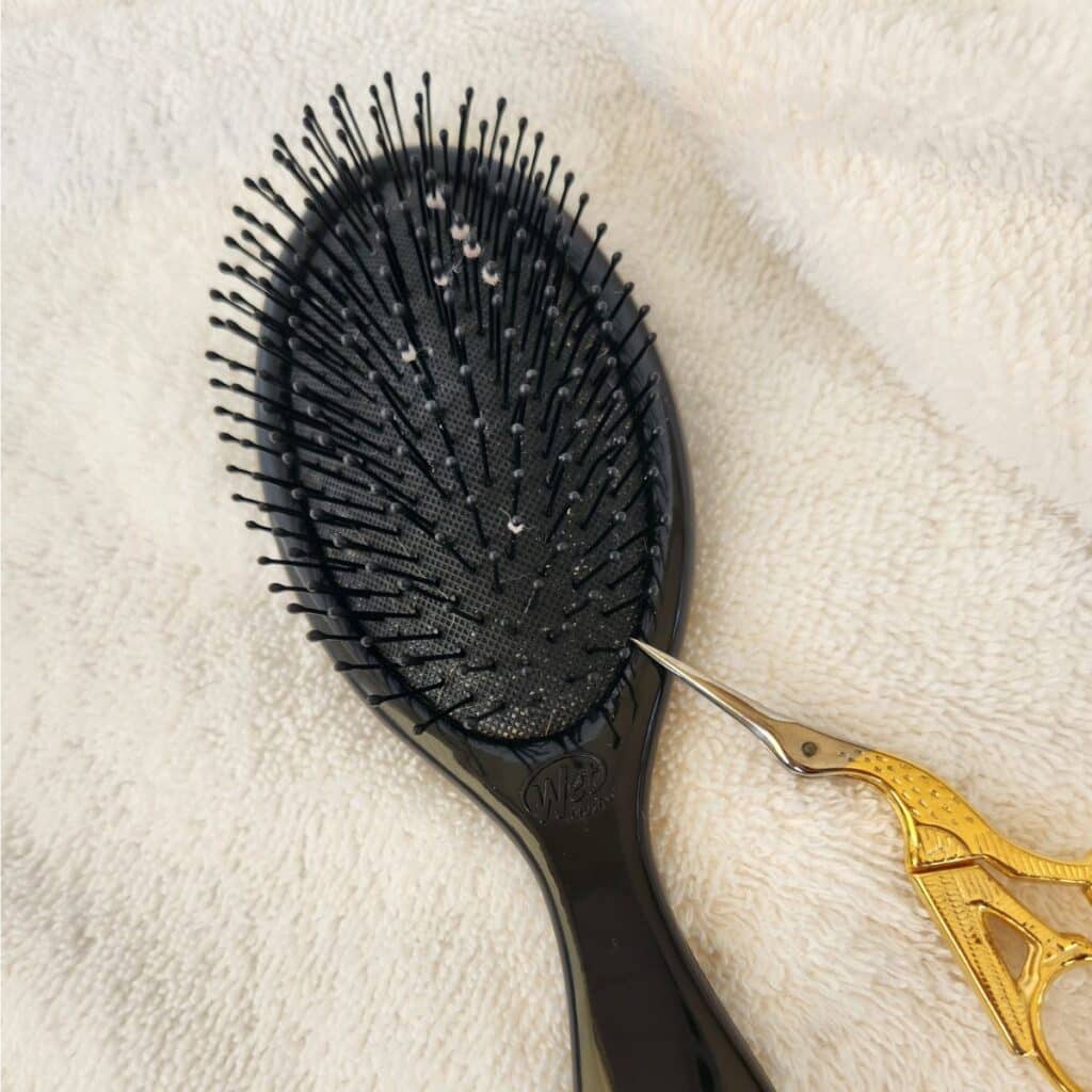 hair brush with grey fuzz on it