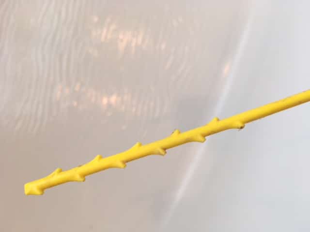 yellow plastic drain snake.