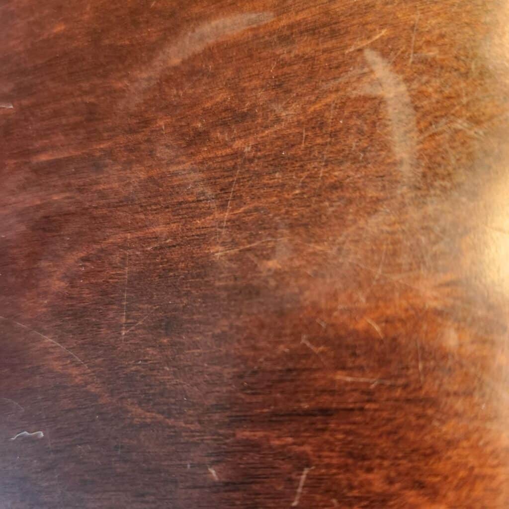 a wooden table with a heat stain.