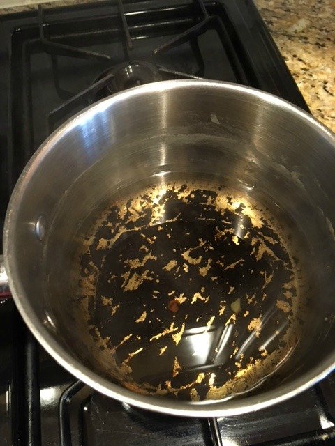 boiling vinegar and baking soda on burnt pot