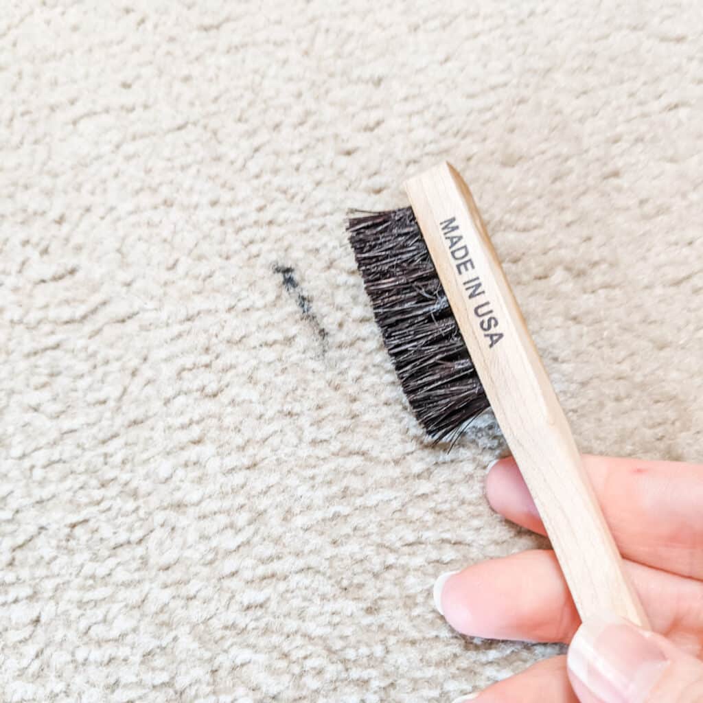 remove dried mascara from carpet with a toothbrush
