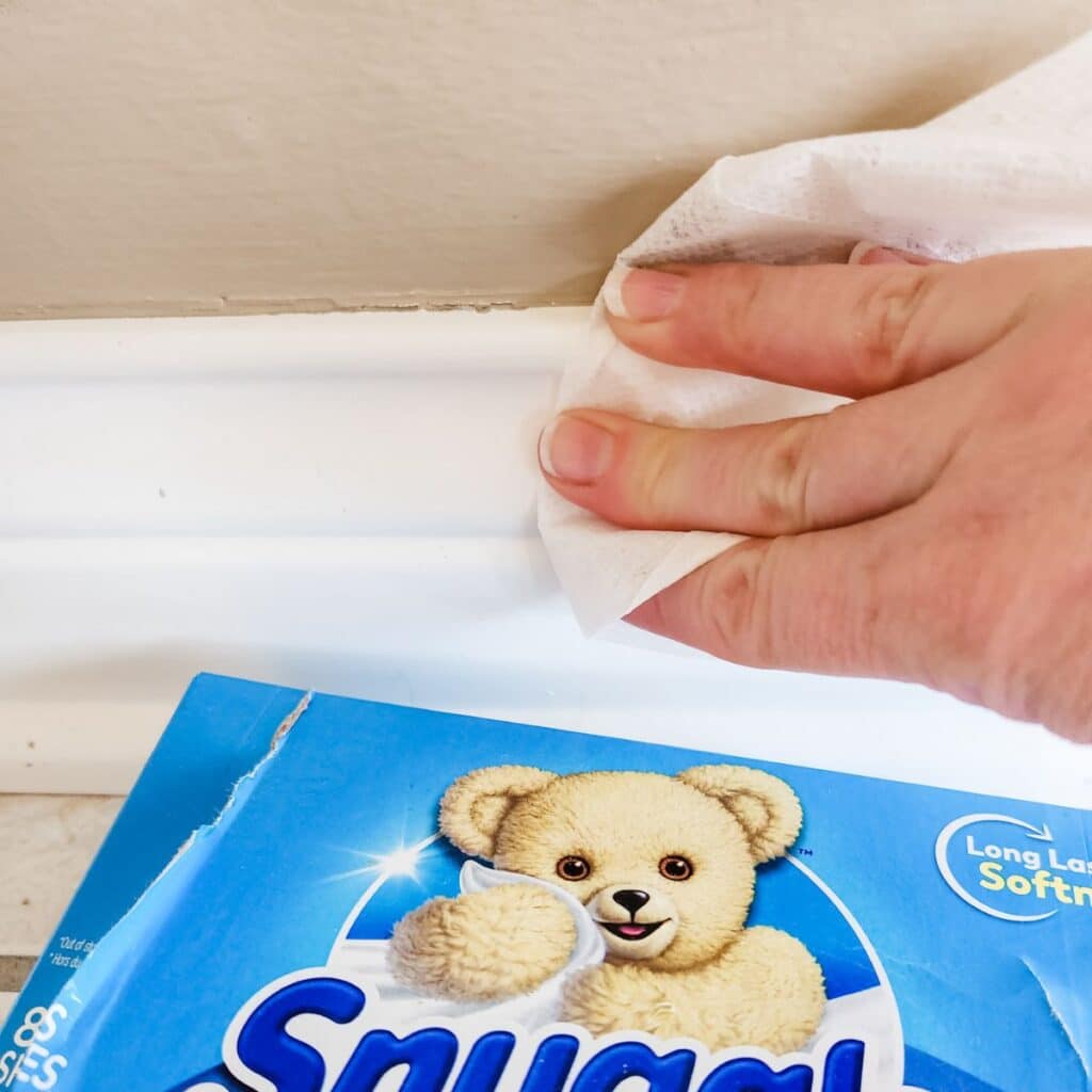 wiping the baseboards with a dryer sheet.