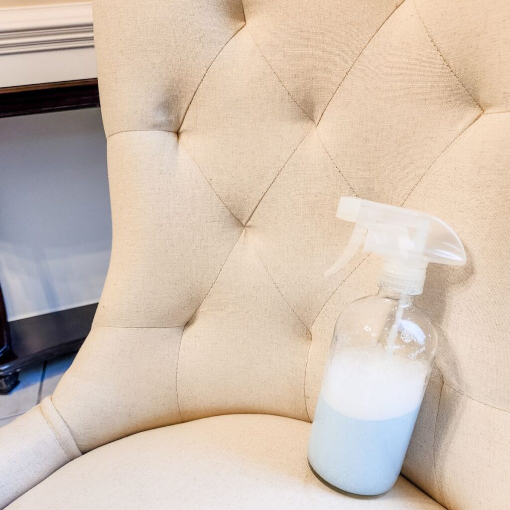 bottle of upholstery cleaner sitting on chair